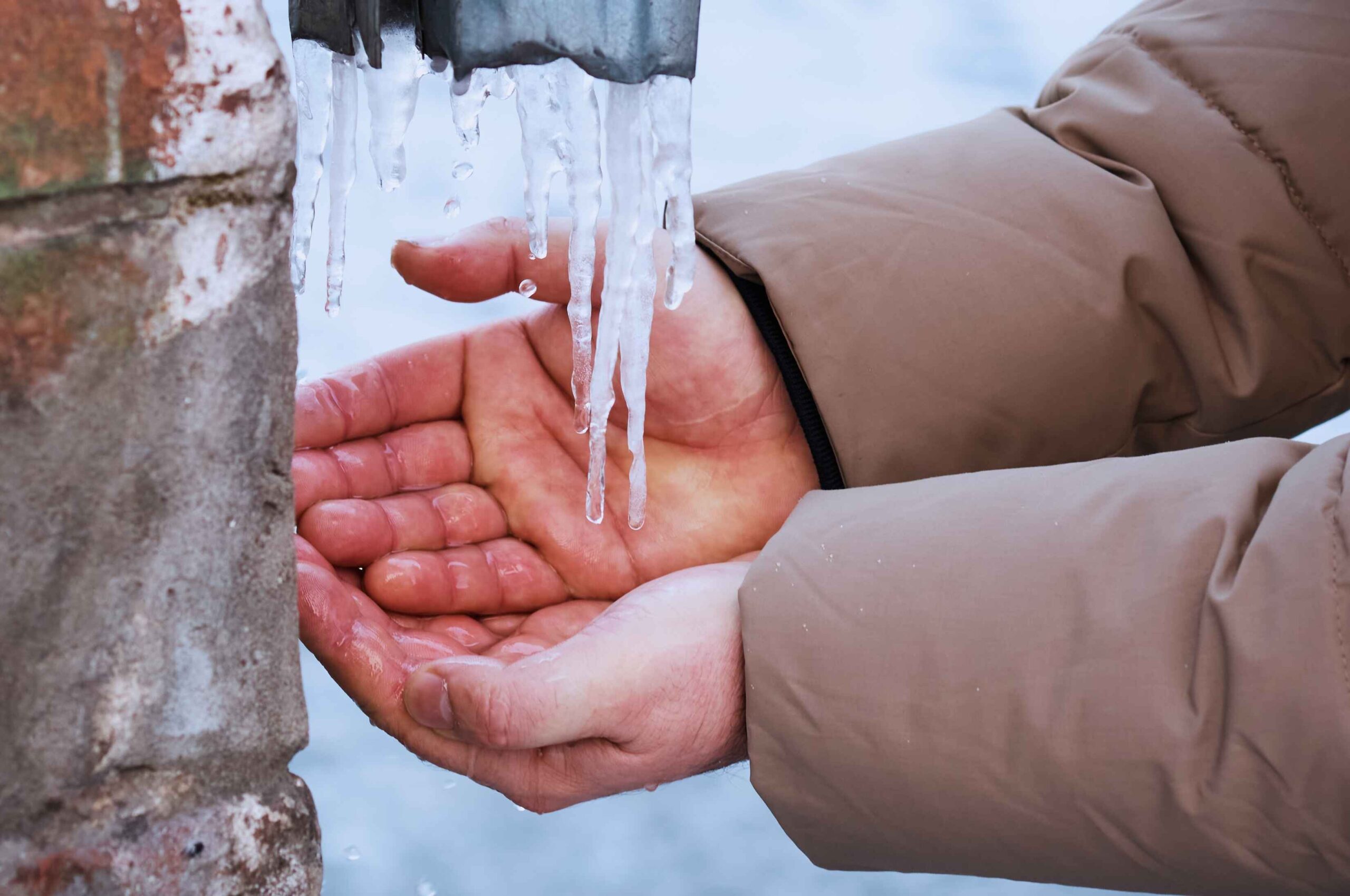 man demonstrating freezing water pipelines