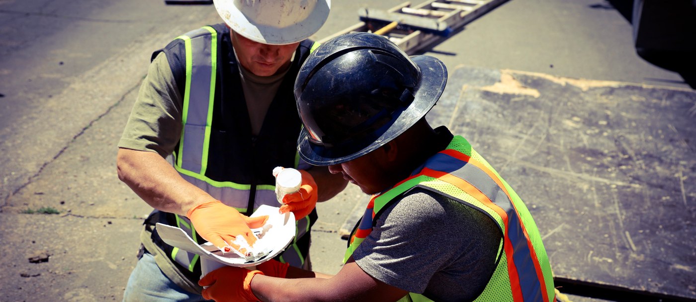 Two Sewer Experts crew members reviewing the job plan on site