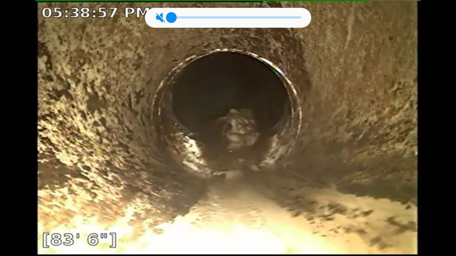 Sewer camera screen showing the inside of a pipe and a distance readout of 83 feet 6 inches