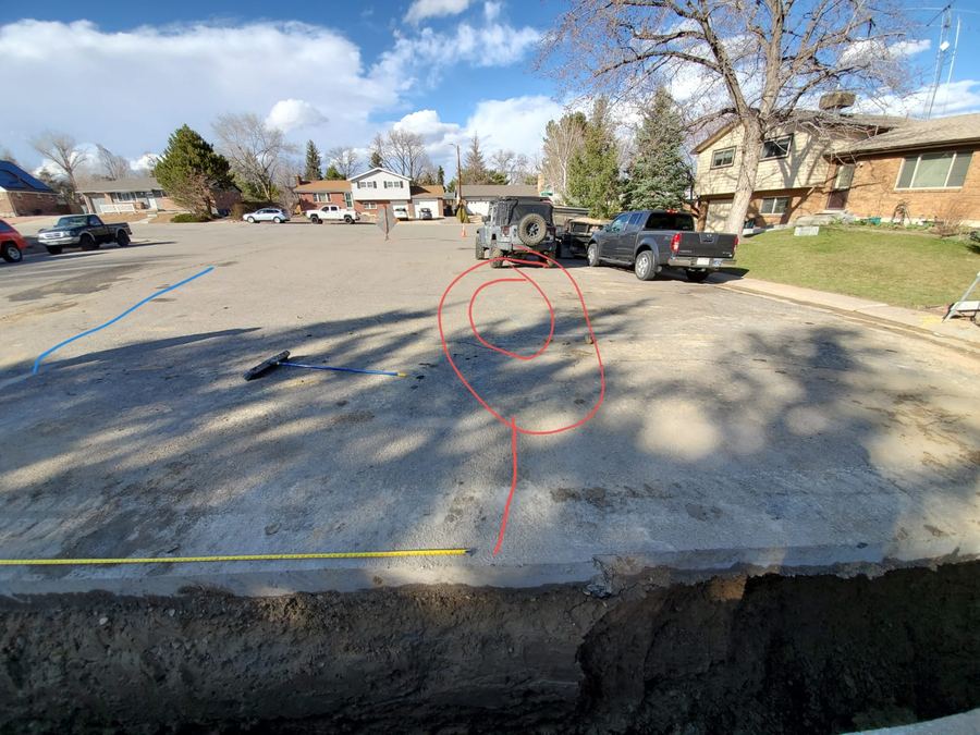 Red spiral mark painted on a driveway where the sonde signal was found