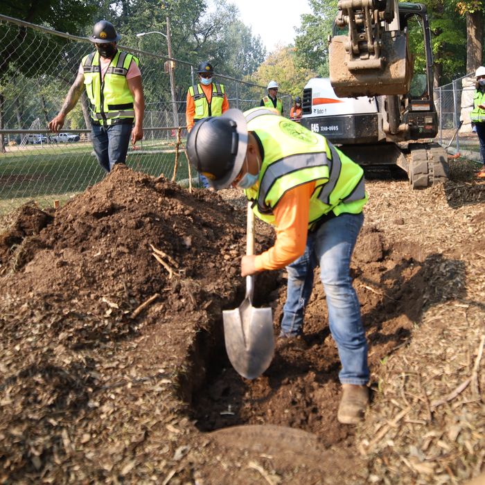 Sewer Experts crew digging a sewer line trench